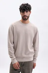 Buzo de tejido de punto color taupe, con cuello redondo y manga larga. Presenta una textura acanalada vertical.