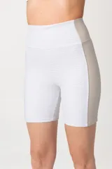 Calza corta deportiva blanca con paneles laterales en color beige.