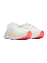 Championes de running Under Armour modelo Halo Runner SE, color blanco con detalles en naranja. Presentan una entresuela voluminosa con diseño estructurado y suela de goma con tracción.