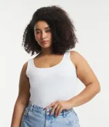 Blusa tipo musculosa blanca, de corte ajustado, con escote cuadrado pronunciado y breteles anchos.