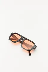 Lentes de sol con marco geométrico negro y lentes con degradé azul.