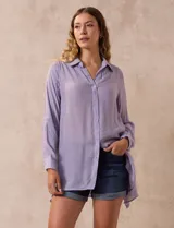 Camisa larga de rayón, con cuello clásico, cierre frontal con botones y mangas regulables con presilla. Presenta un diseño holgado con tajos laterales en el ruedo.