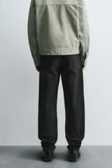 Pantalón de jean corte slim fit, color gris con efecto lavado. Presenta diseño de cinco bolsillos, cierre frontal con cremallera y botón, y tejido elástico.