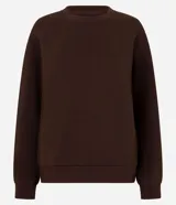 Buzo femenino de cuello redondo y manga larga, confeccionado en tejido de algodón con felpa. Presenta un diseño básico sin estampado, con puños y ruedo ajustados en tejido rib.