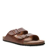 Sandalias de dos bandas ajustables con hebillas metálicas, base de corcho y suela de goma antideslizante.