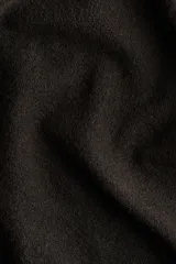 Saco largo de punto fino color marrón oscuro, con hombros caídos, ribete acanalado en nuca, puños y bajo. Sin cierre.