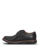 Zapato de cuero negro con cierre de velcro, suela de goma EVA flexible y diseño ergonómico.