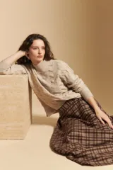 Falda larga de corte amplio y fluido, con estampado de cuadros en tonos marrones y beige. Presenta un diseño de tiro medio con caída suave.