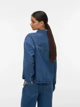 Campera de denim estilo shacket en color azul claro, con cuello clásico, cierre frontal con botones metálicos y amplios bolsillos frontales aplicados.