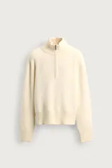 Sweater de punto color beige, con cuello perkins y cierre frontal parcial, de manga larga y calce boxy fit.