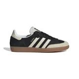 Championes Adidas Samba OG, color negro con detalles en blanco y suela de goma marrón. Inspirados en el modelo icónico de fútbol sala de los años 50, con parte superior de cuero suave, punta reforzada y las emblemáticas 3 Tiras.