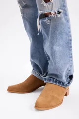 Zapato tipo mocasín de cuero vacuno con textura grabada, diseño de punta fina y taco bajo cuadrado. Cuenta con cierre en la parte posterior del talón.