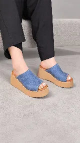 Zueco de plataforma corrida color azul con textura efecto croco, capellada amplia y plantilla en tono suela.