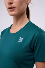 Remera deportiva verde esmeralda con tecnología dryfit y logo estampado en el frente.