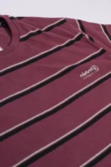 Remera de hombre de corte regular y manga corta, con cuello redondo. Presenta un diseño a rayas horizontales en tonos bordó, negro y blanco, con el logo de la marca estampado en el pecho.