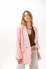 Blazer cruzado de rayas rojas y blancas, con solapas de muesca, bolsillos con solapa en los laterales y cierre de dos botones rojos.