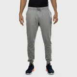 Pantalón deportivo tipo jogging de hombre, color gris melange, con cordón ajustable en la cintura y puños elásticos en los tobillos. Presenta un pequeño logo de la marca en la parte superior del muslo derecho.