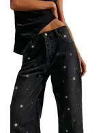 Pantalón de jean negro, de corte recto y estilo relajado, con bordado de estrellas en color dorado.