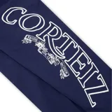 Pantalón de jogging azul marino con estampado gráfico blanco en la pierna derecha y logo circular en la pierna izquierda. Cuenta con cintura elástica y bolsillos laterales.