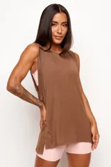 Musculosa de corte holgado y diseño minimalista, confeccionada en una mezcla de viscosa, lino y elastano. Presenta sisas amplias y aberturas laterales en el ruedo, ofreciendo una caída natural y ligera.