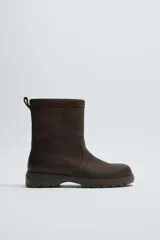 Bota de cuero con acabado abatanado, horma redonda y suela track con volumen. Cuenta con plantilla interior de cuero y tirador en la parte trasera.