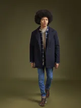 Abrigo de paño azul marino con doble botonadura, cuello con solapas y bolsillos laterales.