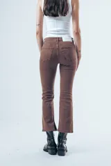 Jean de corte bootcut y tiro medio, color gris oscuro desgastado. Presenta un diseño de pierna recta que se ensancha ligeramente hacia el ruedo, con cierre frontal y bolsillos clásicos.