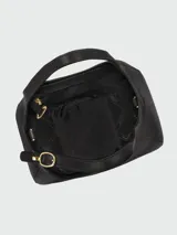 Cartera de mano tamaño pequeño Longchamp de la línea Le Foulonné, confeccionada en cuero negro con diseño estructurado de forma semicircular, asa superior y correa ajustable.
