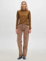 Polera de manga larga confeccionada en tela rib color marrón, con hombreras y costuras a la vista con pespuntes en hilo azul en cuello, hombros y puños.