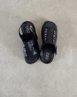 Sandalias negras de cuero vacuno con plataforma y hebilla lateral.