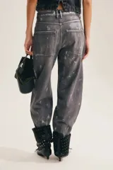 Jean slouchy de tiro alto con silueta barrel de color gris con efecto plateado desgastado y textura geométrica.