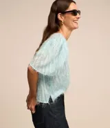 Blusa de chiffon azul marino con cuello redondo, mangas cortas con pliegues en los hombros y textura con felpas.