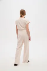 Pantalón de viscosa color verde militar, de corte ancho y tiro alto, con detalle de plisado en la cintura.