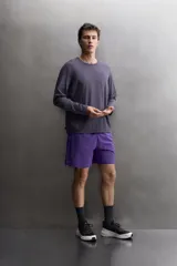 Pantalones deportivos cortos Zara Athleticz, confeccionados en tejido técnico ligero y elástico en color celeste. Cuenta con cintura elástica ajustable, bolsillos frontales, bajo con aberturas laterales y detalle de logo estampado.