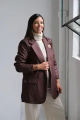 Blazer de corte sastrero en color marrón chocolate, con solapas clásicas, bolsillos delanteros con solapa y costuras a la vista en tono contrastante.
