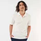Remera polo de piqué de algodón en color beige, con cuello camisero y cierre frontal de botones.