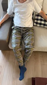 Pantalón de hombre confeccionado en franela con diseño a cuadros de estilo escocés en tonos gris, amarillo y verde. Cuenta con cintura elástica con cordón de ajuste y bolsillos laterales.
