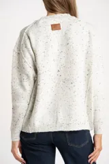 Sweater de punto con diseño jaspeado, cuello redondo y corte oversize. Presenta costuras visibles en los hombros y puños acanalados.