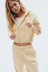 Jogging de felpa color amarillo pálido, con interior cepillado suave. Presenta cintura elástica fruncida con cordón ajustable y elástico revestido en los bajos.