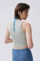 Top tejido color verde claro, de corte cropped y cuello redondo.