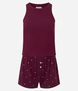 Pijama de dos piezas compuesto por una musculosa de tejido acanalado y un short con estampado de lunares. El short cuenta con cintura elástica y detalle de botones frontales decorativos.