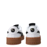 Championes Puma Carina 3.0 de mujer, color blanco con detalles en lila y logo dorado. Inspirados en la moda playera californiana de los años 80, con suela de plataforma y plantilla SOFTFOAM+ para mayor amortiguación.