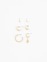 Set de aros dorados con diferentes diseños: dos aros pequeños con forma de flor, dos aros pequeños con textura trenzada, dos aros medianos con textura trenzada y un aro pequeño con dije colgante en forma de rombo.