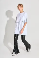 Remerón blanco de jersey 24/1 peinado, corte oversized, mangas cortas y ruedo ancho. Estampa serigrafiada en frente y espalda a contratono.