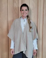 Ruana abierta de tejido de punto acanalado en color beige, con diseño holgado y caída fluida.