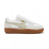 Championes Puma modelo Palermo, con diseño retro de perfil bajo. Presentan una combinación de cuero blanco y gamuza en tonos claros, con la icónica franja lateral en color beige y suela de goma color caramelo. Incluyen el logo de la marca en dorado en el lateral y la lengüeta.