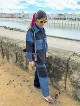 Pantalón cargo de jean y tela negra, con bolsillos laterales y corte holgado.