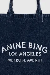 Bolso tipo tote bag de denim azul con doble asa superior y estampado frontal en blanco de la marca Anine Bing Los Angeles Melrose Avenue.