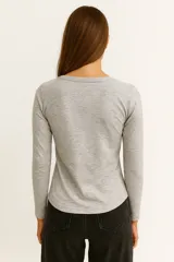 Remera de manga larga color blanco, de corte ajustado al cuerpo y cuello redondo.