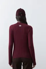 Polera de tejido de punto con cuello alto y diseño de rayas verticales sutiles. Presenta un ajuste al cuerpo y mangas largas.